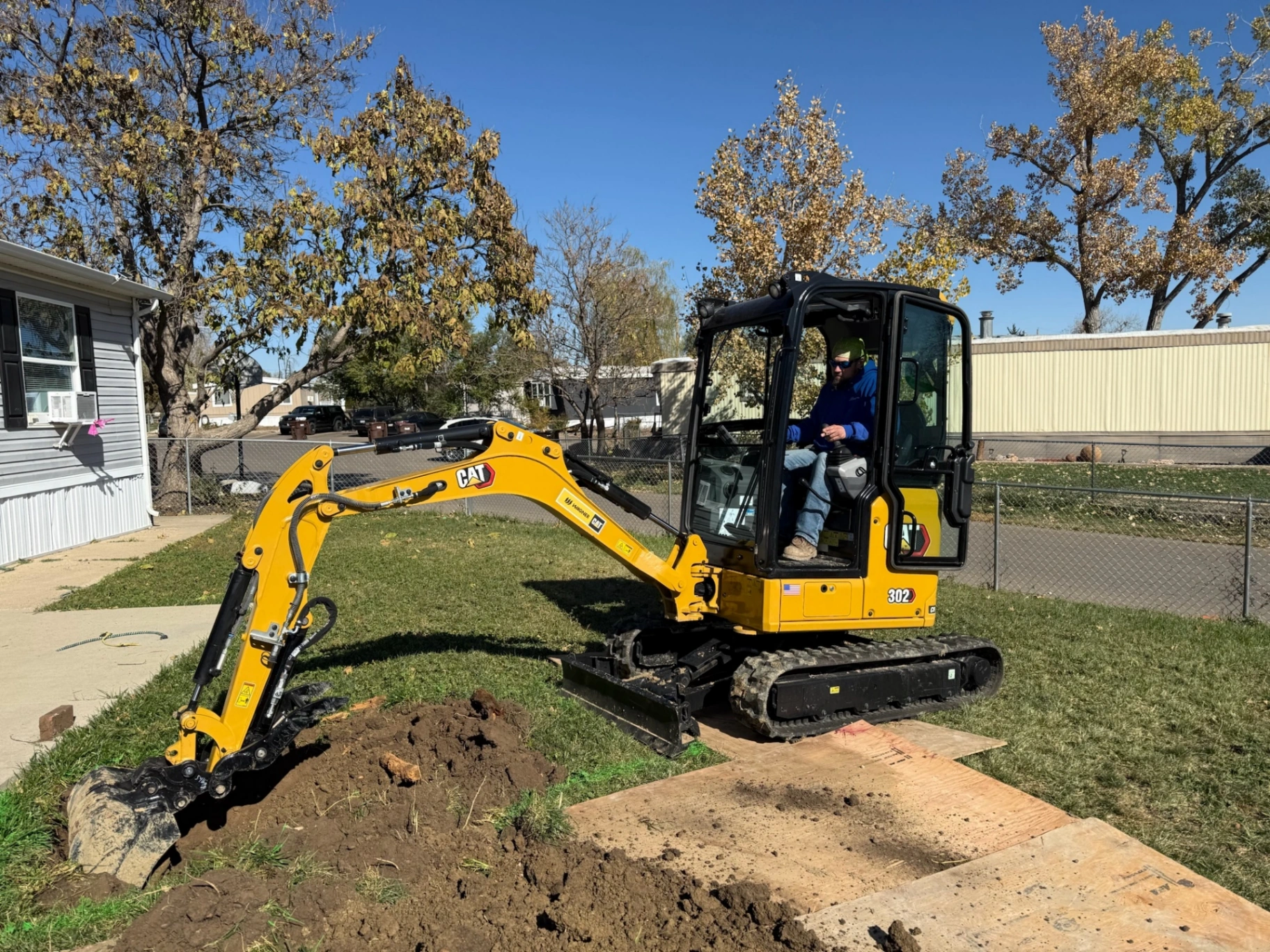 Mini excavator digging a utility trench
