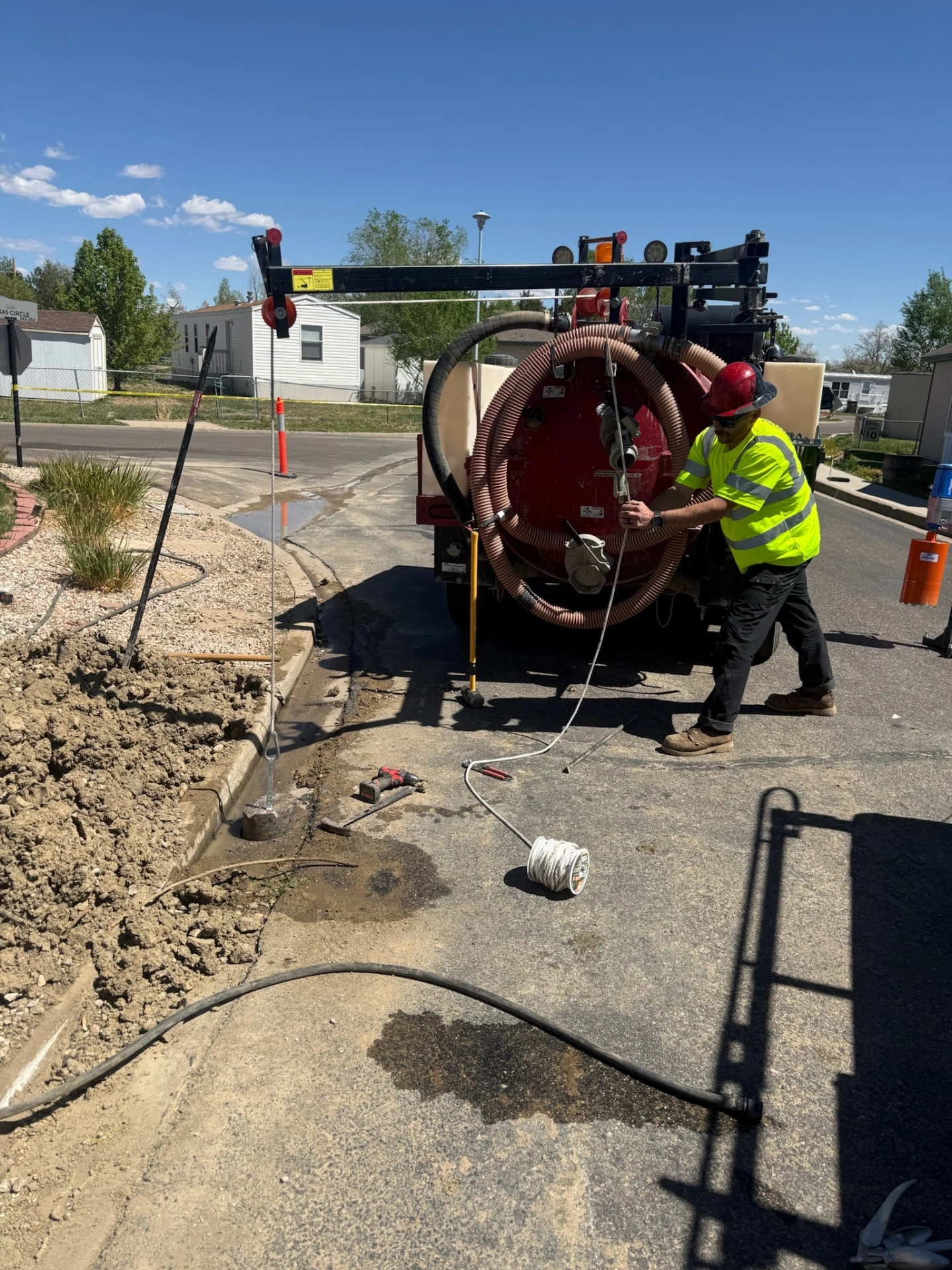 Vac-truck water service work on a residential street